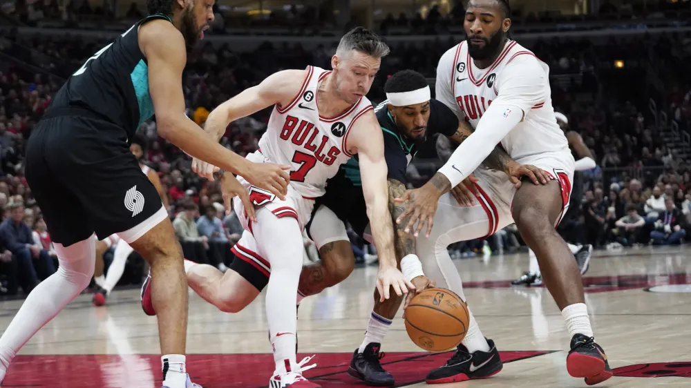 Feb 4, 2023; Chicago, Illinois, USA; Chicago Bulls guard Goran Dragic (7) and Chicago Bulls center Andre Drummond (right) and Portland Trail Blazers guard Gary Payton II (00) go for a loose ball during the first quarter at United Center. Mandatory Credit: David Banks-USA TODAY Sports