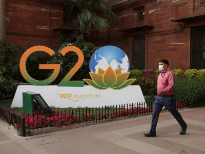 A man walks past a model of G20 logo outside the finance ministry in New Delhi, India, March 1, 2023. REUTERS/Anushree Fadnavis