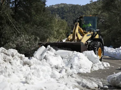 01 March 2023, Spain, Escora: A heavy wheel loader pushes snow from the road in the Escora pilgrimage site near the monastery of Lluc. Mallorca has requested the help of the Spanish military emergency aid unit as it struggles to deal with a storm that brought more than 1 metre of snow to the island. Photo: Clara Margais/dpa