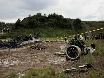 Emergency personnel work at the accident site of a Saurya Airlines plane that caught fire after skidding off the runway while taking off at Tribhuvan International Airport, in Kathmandu, Nepal July 24, 2024.  REUTERS/Navesh Chitrakar