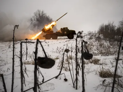 FILE - Ukrainian servicemen of the Prince Roman the Great 14th Separate Mechanized Brigade fire a Soviet era Grad multiple rocket launcher at Russian positions in the Kharkiv area, Ukraine, Saturday, Feb. 25, 2023. Grueling artillery battles have stepped up in recent weeks in the vicinity of Kupiansk, a strategic town on the eastern edge of Kharkiv province by the banks of the Oskil River as Russian attacks intensifying in a push to capture the entire industrial heartland known as the Donbas, which includes the Donetsk and the Luhansk provinces. (AP Photo/Vadim Ghirda, File)