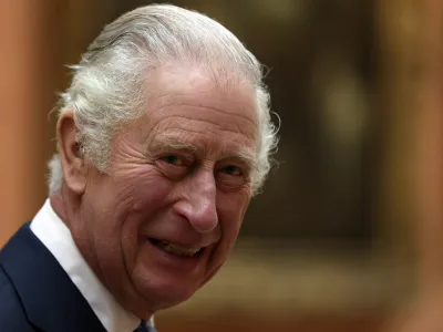 FILE - Britain's King Charles III meets members of the Westend Gospel Choir after a ceremony commemorating the 50th anniversary of the Resettlement of British Asians from Uganda in the U.K., at Buckingham Palace in London on Nov. 2, 2022. Two senior clergymen in Jerusalem on Friday March 3, 2023, consecrated the holy oil that will be used to anoint King Charles III during his coronation, as the Anglican Church seeks to underscore the monarchy's long history and the royal family's links to the Middle East. (Isabel Infantes/Pool via AP, File)