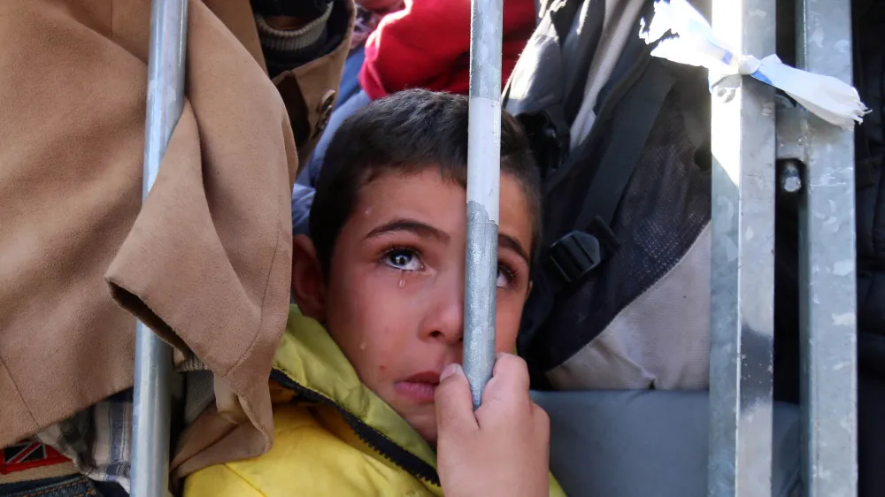 ﻿A migrant boy waits to cross the border between Slovenia and Austria in Sentilj, Slovenia, Wednesday, Nov. 4, 2015. Hundreds of thousands of migrants have flooded to northern Europe in recent months seeking to escape war and poverty and start a new life. (AP Photo/Ronald Zak)