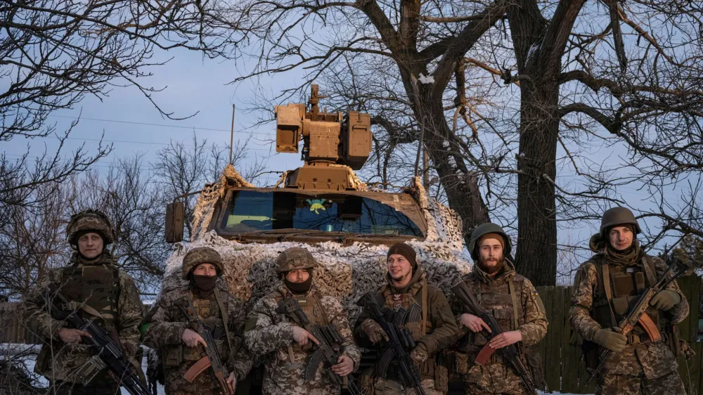 Ukrainian servicemen of the 80th Air Assault Brigade stand in front of a Bushmaster Protected Mobility Vehicle, amid Russia's attack on Ukraine, near Bahmut, Donetsk region, Ukraine, February 16, 2023. REUTERS/Marko Djurica