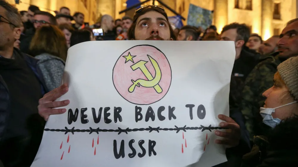 Participants protest against a draft law on "foreign agents", which critics say represents an authoritarian shift and could hurt Georgia's bid to join the European Union, during a rally outside the parliament building in Tbilisi, Georgia, March 8, 2023. REUTERS/Irakli Gedenidze