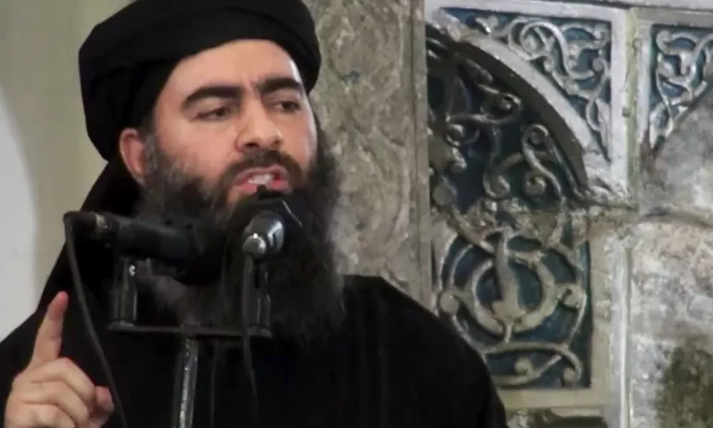 FILE - This file image made from video posted on a militant website Saturday, July 5, 2014, purports to show the leader of the Islamic State group, Abu Bakr al-Baghdadi, delivering a sermon at a mosque in Iraq during his first public appearance. The Islamic State group has released a new message purportedly from its reclusive leader, claiming his self-styled ?caliphate? is doing ?well? despite an unprecedented alliance against it. (AP Photo/Militant video, File)