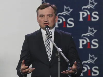 FILE - The current Poland's justice minister Zbigniew Ziobro, speaks to reporters alongside in Warsaw, Poland, Saturday, Sept. 26, 2020. Poland's divisive justice minister, Zbigniew Ziobro, has drawn surprised comments after a gust of wind revealed that he carries a gun tucked in his belt. (AP Photo/Czarek Sokolowski, File)