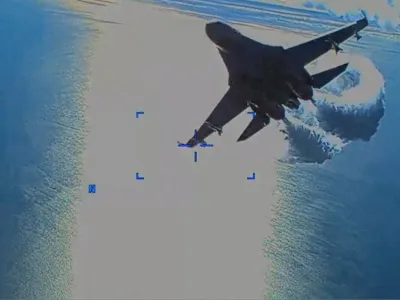 A Russian Su-27 military aircraft dumps fuel while flying by a U.S. Air Force MQ-9 "Reaper" drone over the Black Sea, March 14, 2023 in this still image taken from handout video released by the Pentagon. Courtesy of U.S. European Command/The Pentagon/Handout via REUTERS THIS IMAGE HAS BEEN SUPPLIED BY A THIRD PARTY. MANDATORY CREDIT.