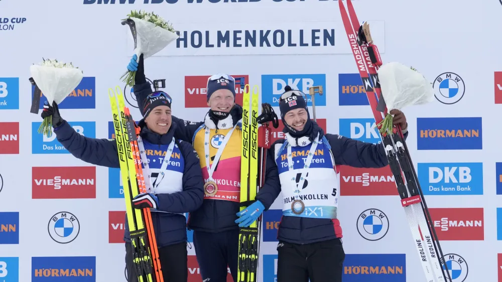 18 March 2023, Norway, Oslo: France's second-placed Quentin Fillon Maillet, Norway's first-placed Johannes Thingnes Boe, and Norway's third-placed Sturla Holm Laegreid celebrate on the podium after winning the men's pursuit race during the International Biathlon Union (IBU) World Cup in Holmenkollen. Photo: Javad Parsa/NTB/dpa