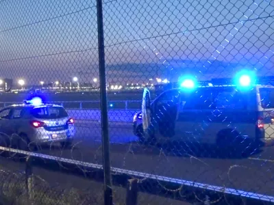 25 July 2024, Hesse, Frankfurt/Main: Police vehicles are parked near the tarmac at Frankfurt Airport. Air traffic has been temporarily suspended due to an action by climate activists. Photo: Mike Seeboth/TNN/dpa