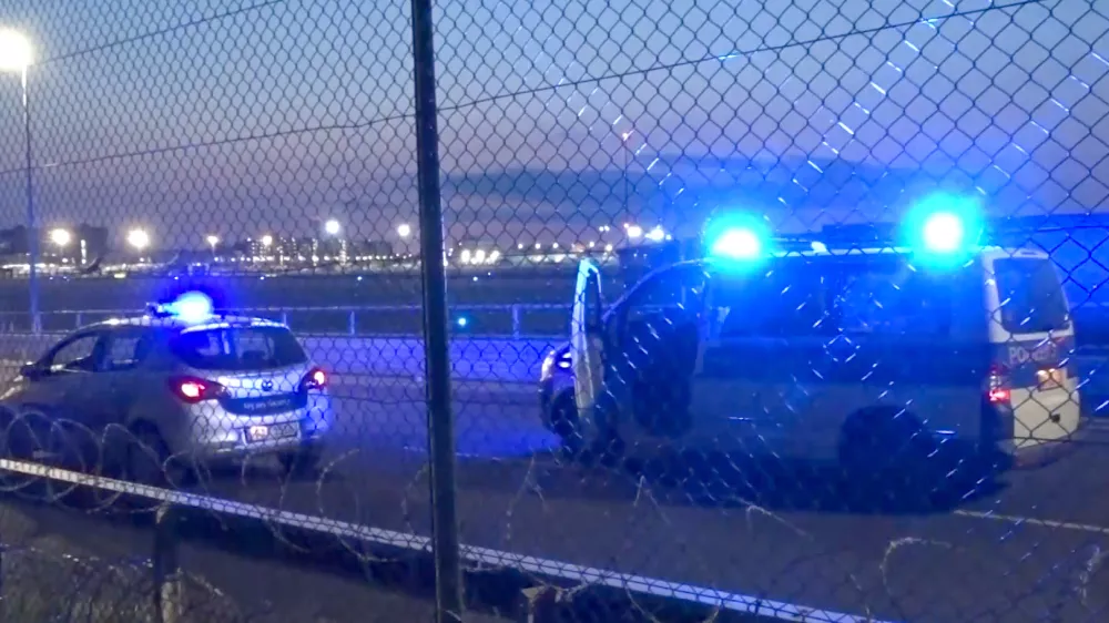 25 July 2024, Hesse, Frankfurt/Main: Police vehicles are parked near the tarmac at Frankfurt Airport. Air traffic has been temporarily suspended due to an action by climate activists. Photo: Mike Seeboth/TNN/dpa