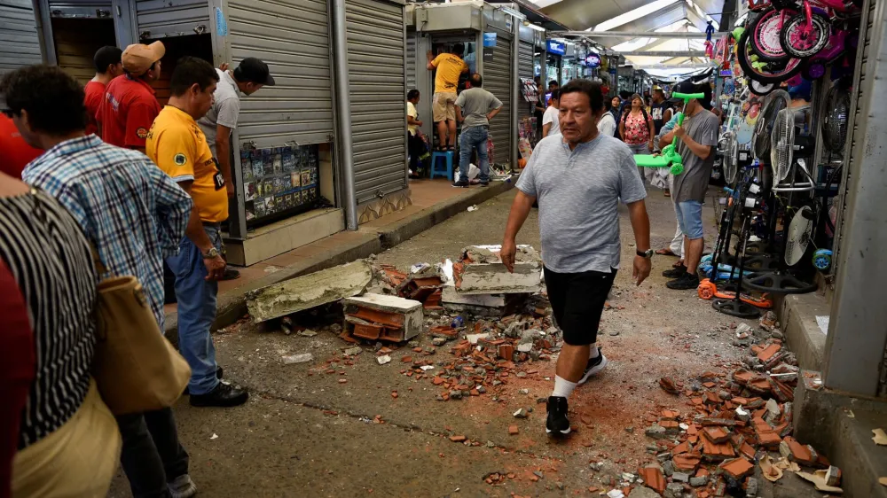 A man passes by debris following an earthquake in Guayaquil, Ecuador March 18, 2023. REUTERS/Vicente Gaibor Del Pino