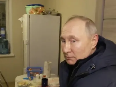 In this photo taken from video released by Russian TV Pool on Sunday, March 19, 2023, Russian President Vladimir Putin listens to local residents at their new flat during his visit to Mariupol in Russian-controlled Donetsk region, Ukraine. Putin has traveled to Crimea to mark the ninth anniversary of the Black Sea peninsula's annexation from Ukraine. (Pool Photo via AP)