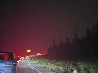 This photo provided by Carolyn Campbell shows cars clogging the highway as people evacuate because of wildfires early Tuesday, July 23, 2024, in Jasper, Alberta. Multiple wildfires in Canada's Jasper National Park have flared up, forcing all park visitors along with the 4,700 residents of the Jasper townsite to flee. (Carolyn Campbell/The Canadian Press via AP)