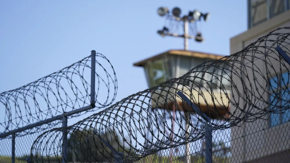 Razor wire is seen below a guard tower at San Quentin State Prison in San Quentin, Calif., Friday, March 17, 2023. Gov. Gavin Newsom plans to transform San Quentin State Prison, a facility in the San Francisco Bay Area known for maintaining the highest number of prisoners on death row in the country. Newsom said his goal is to turn the prison into a place where inmates can be rehabilitated and receive job training before returning to society. (AP Photo/Eric Risberg)