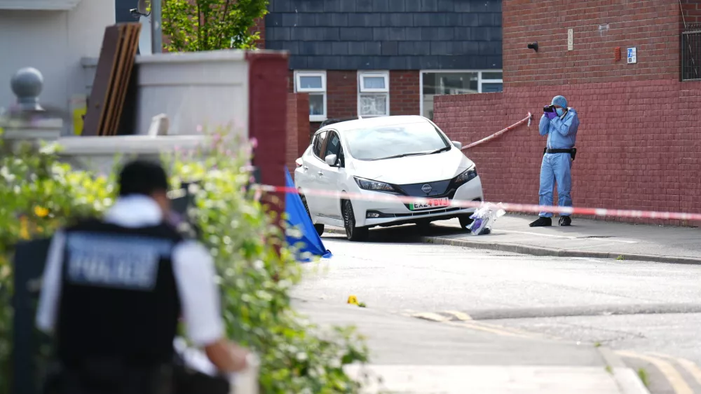 24 July 2024, United Kingdom, London: A forensic officer at the scene in Stellman Close in Hackney, where a 15-year-old boy died after being stabbed at about 4pm on Tuesday. A 15-year-old boy has been arrested on suspicion of murdering the teenager. Photo: -/PA Wire/dpa