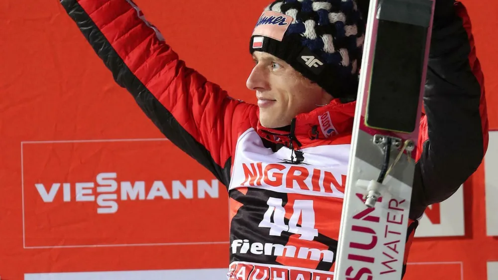 ﻿Second placed Dawid Kubacki of Poland celebrates on the podium after the men's HS135 ski jumping competition in Val di Fiemme, Italy, Saturday, Jan. 12, 2019. (Andrea Solero/ANSA via AP)