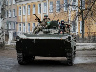 Ukrainian service members ride a BMP-1 infantry fighting vehicle, as Russia's attack on Ukraine continues, in the front line city of Chasiv Yar, in Donetsk region, Ukraine March 19, 2023. REUTERS/Alex Babenko