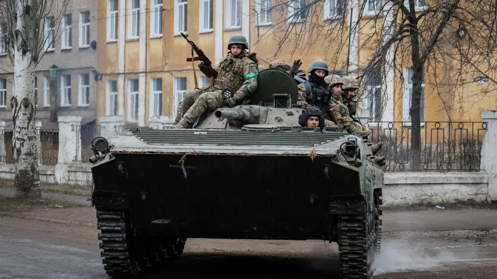 Ukrainian service members ride a BMP-1 infantry fighting vehicle, as Russia's attack on Ukraine continues, in the front line city of Chasiv Yar, in Donetsk region, Ukraine March 19, 2023. REUTERS/Alex Babenko