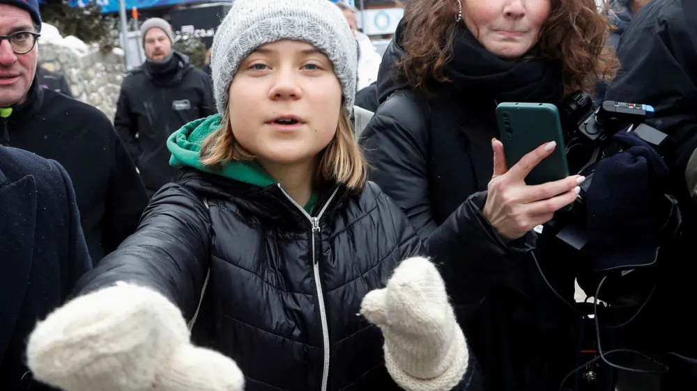 FILE PHOTO: Climate activist Greta Thunberg gestures as she walks outside during the World Economic Forum in Davos (WEF) in Davos, Switzerland January 19, 2023. REUTERS/Arnd Wiegmann/File Photo