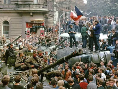 Prague residents surround Soviet tanks in front of the Czechoslovak Radio station building in central Prague during the first day of Soviet-led invasion to then Czechoslovakia August 21, 1968. Vera Machutova woke one August night in 1968 to the thunder of Soviet tanks surging through this Czech city on the East German frontier. Forty years later, with the Czech Republic now a democracy within NATO and the European Union, Machutova is troubled by the conflict in Georgia, whose army was routed last week by Russian forces that pushed deep inside its territory. The banner reads, "Entry forbidden to unauthorized personnel". Picture taken August 21, 1968. To match feature CZECH-RUSSIA/INVASION   REUTERS/Libor Hajsky (CZECH REPUBLIC)