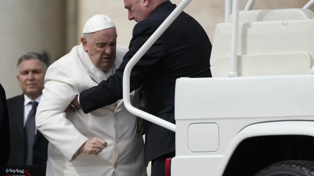 Pope Francis is helped into his car at the end of the weekly general audience in St. Peter's Square, at the Vatican, Wednesday, March 29, 2023. Pope Francis went to a Rome hospital on Wednesday for some previously scheduled tests, slipping out of the Vatican after his general audience and before the busy start of Holy Week this Sunday. (AP Photo/Alessandra Tarantino)