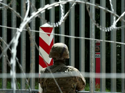 FILE PHOTO: A soldier stands guard near the fence on the Belarusian-Polish border in the forest near Bialowieza, Poland, June 4, 2024. REUTERS/Kacper Pempel/File Photo