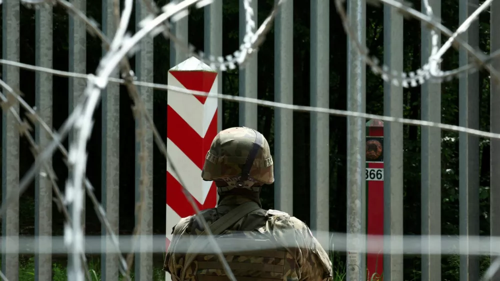 FILE PHOTO: A soldier stands guard near the fence on the Belarusian-Polish border in the forest near Bialowieza, Poland, June 4, 2024. REUTERS/Kacper Pempel/File Photo