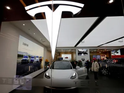 FILE PHOTO: Visitors check a Tesla Model 3 car next to a Model Y displayed at a showroom of the U.S. electric vehicle (EV) maker in Beijing, China February 4, 2023. REUTERS/Florence Lo/File Photo