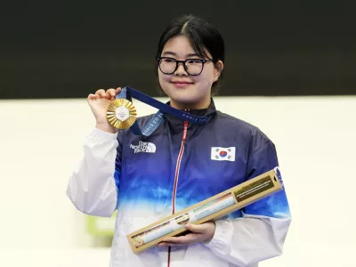 South Korea's Oh Ye-Jin poses for a photograph with her gold medal after winning the 10m air pistol women's final round at the 2024 Summer Olympics, Sunday, July 28, 2024, in Chateauroux, France. Oh Ye-Jin won the gold medal while Kim Yeji won the silver in the competition. (AP Photo/Manish Swarup)