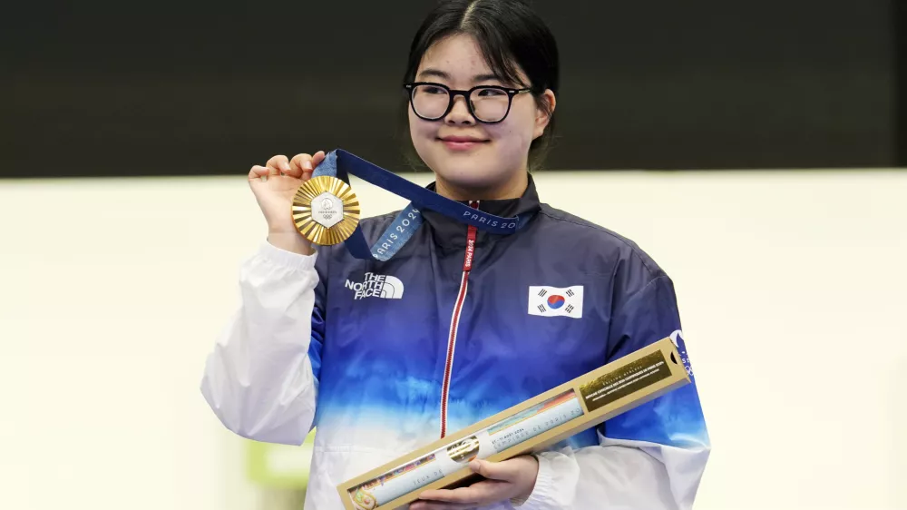 South Korea's Oh Ye-Jin poses for a photograph with her gold medal after winning the 10m air pistol women's final round at the 2024 Summer Olympics, Sunday, July 28, 2024, in Chateauroux, France. Oh Ye-Jin won the gold medal while Kim Yeji won the silver in the competition. (AP Photo/Manish Swarup)