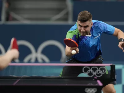 Slovenia's Darko Jorgic plays against Singapore's Izaac Quek during a men's singles round of 64 table tennis game at the 2024 Summer Olympics, Sunday, July 28, 2024, in Paris, France. (AP Photo/Petros Giannakouris)