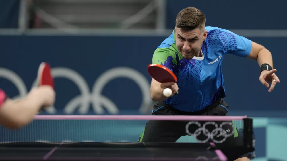 Slovenia's Darko Jorgic plays against Singapore's Izaac Quek during a men's singles round of 64 table tennis game at the 2024 Summer Olympics, Sunday, July 28, 2024, in Paris, France. (AP Photo/Petros Giannakouris)