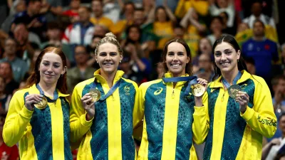 Paris 2024 Olympics - Swimming - Women's 4x100m Free Relay Victory Ceremony - Paris La Defense Arena, Nanterre, France - July 27, 2024. Gold medallists Mollie O'Callaghan of Australia, Emma McKeon of Australia, Meg Harris of Australia, Shayna Jack of Australia celebrate on the podium after winning the race. REUTERS/Clodagh Kilcoyne REFILE - CORRECTING EVENT TEMPLATE