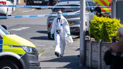 29 July 2024, United Kingdom, Southport: A police scenes of crime officer (SOCO) works at the scene in Southport, Merseyside, where a man has been detained and a knife seized after a number of people were injured in a reported stabbing. Eight patients with stab injuries have been treated at the scene and taken to hospitals including Alder Hey Children's Hospital. Photo: James Speakman/PA Wire/dpa