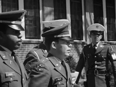 Lt. William Calley is escorted to the Fort Benning stockade to begin his lifeterm in prison for his part in the My Lai massacre during the Vietnam War. Calley's sentence was later reduced and he was released on parole in November 1975. March 31, 1971 Fort Benning, Georgia, USA