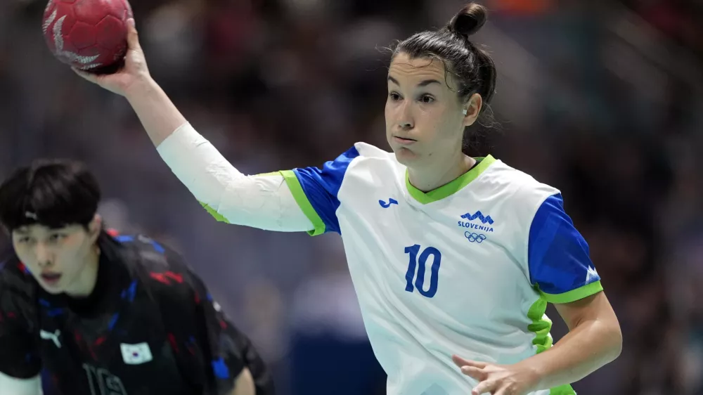 Tjasa Stanko, of Slovenia, prepares to shoot the ball past Han Miseul, of South Korea, during a women's handball match at the 2024 Summer Olympics, Sunday, July 28, 2024, in Paris, France. (AP Photo/Brian Inganga)