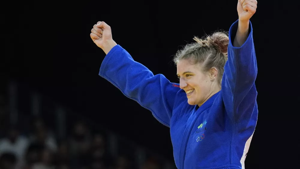 Slovenia's Andreja Leski celebrates after defeating Mexico's Prisca Awiti Alcaraz during their women -63 kg final match in team judo competition at Champ-de-Mars Arena during the 2024 Summer Olympics, Tuesday, July 30, 2024, in Paris, France. (AP Photo/Eugene Hoshiko)