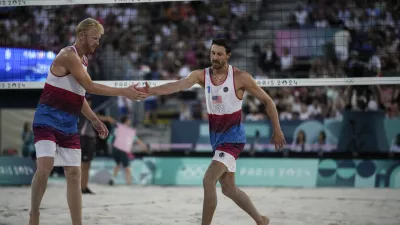 US' Chase Budinger, left, and Miles Evans react during the men's pool F beach volleyball match between Netherlands and USA at Eiffel Tower Stadium at the 2024 Summer Olympics, Tuesday, July 30, 2024, in Paris, France. (AP Photo/Louise Delmotte)