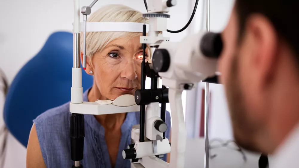 Ophthalmology concept. Senior woman eye vision examination in ophthalmological clinic