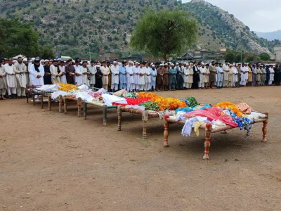 People attend the funeral of victims who died after monsoon rain flooded the basement of a house, killing 11 family members, in Dara Adam Khel, in the Kohat District of Khyber Pakhtunkhwa, Pakistan July 30, 2024. REUTERS/Stringer  NO RESALES. NO ARCHIVES