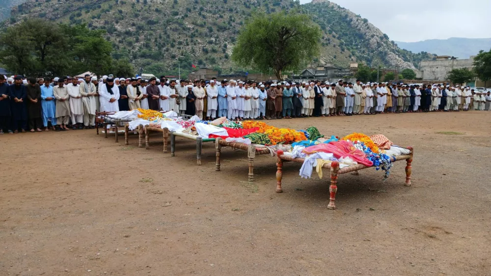 People attend the funeral of victims who died after monsoon rain flooded the basement of a house, killing 11 family members, in Dara Adam Khel, in the Kohat District of Khyber Pakhtunkhwa, Pakistan July 30, 2024. REUTERS/Stringer  NO RESALES. NO ARCHIVES