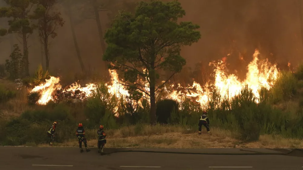 Firefighters attempt to control the wildfire in Tucepi, Croatia, early Wednesday, July 31, 2024. Croatia's Firefireghters' Association described the last 24 hours as "the most demanding so far," with more than 100 interventions over 1,000 firefighters and 20 firefighting planes. (Ivo Ravlic, Cropix via AP)