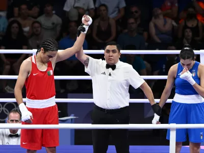 01 August 2024, France, Paris: Algeria's Imane Khelif (Red) celebrates after Italy's Angela Carini abandoned the bout during the Women's 66kg round of 16 at North Paris Arena as part of the 2024 Paris Summer Olympic Games. Photo: Joel Carrett/AAP/dpa