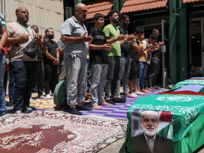 Demonstrators pray near a mock coffin during a protest against the killing of Hamas chief Ismail Haniyeh in Iran, in Lebanon's capital Beirut August 2, 2024. REUTERS/Emilie Madi