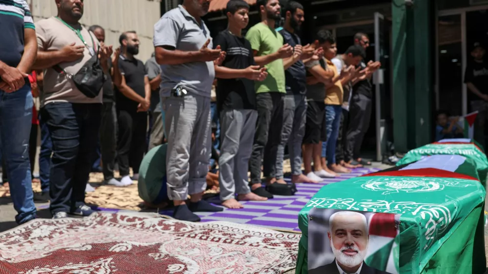 Demonstrators pray near a mock coffin during a protest against the killing of Hamas chief Ismail Haniyeh in Iran, in Lebanon's capital Beirut August 2, 2024. REUTERS/Emilie Madi