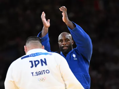 03 August 2024, France, Paris: France's Teddy Riner (Blue) reacts after beating Japan's Tatsuru Saito in the judo mixed team gold medal bout between Japan and France at the Paris 2024 Olympic Games in the Champ-de-Mars Arena. Photo: Marijan Murat/dpa