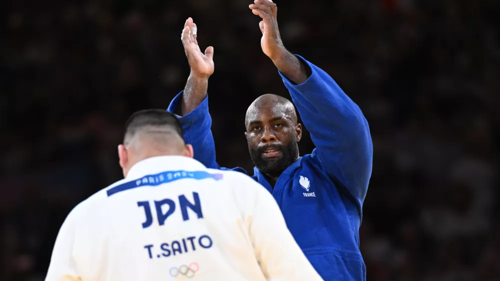 03 August 2024, France, Paris: France's Teddy Riner (Blue) reacts after beating Japan's Tatsuru Saito in the judo mixed team gold medal bout between Japan and France at the Paris 2024 Olympic Games in the Champ-de-Mars Arena. Photo: Marijan Murat/dpa