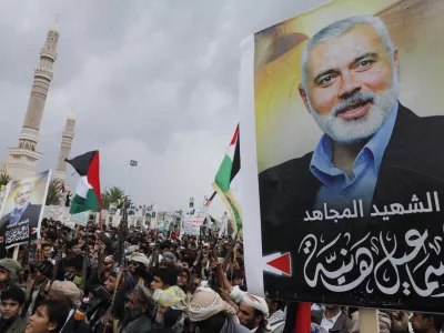 Yemenis protest to condemn the killing of Hamas leader Ismail Haniyeh, in Sanaa, Yemen, Friday, Aug. 2, 2024. Arabic reads, "Martyr Ismail Haniyeh". (AP Photo/Osamah Abdulrahman)