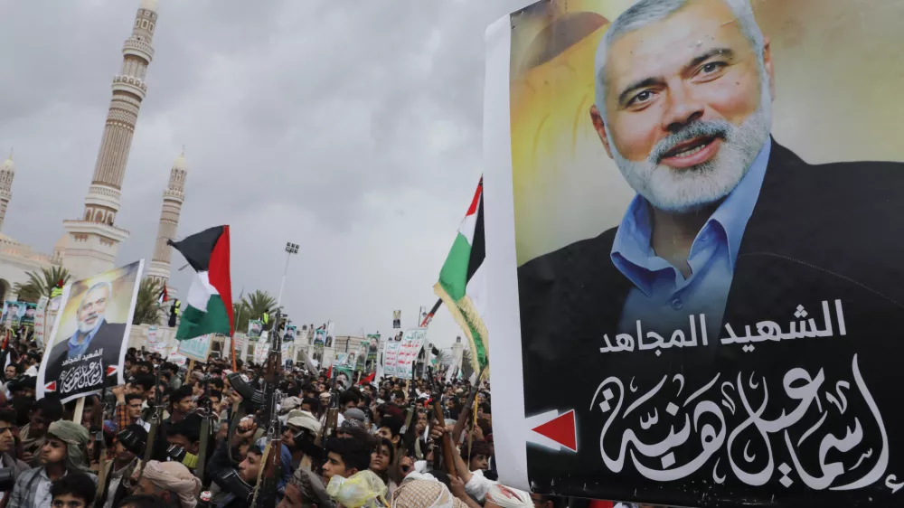 Yemenis protest to condemn the killing of Hamas leader Ismail Haniyeh, in Sanaa, Yemen, Friday, Aug. 2, 2024. Arabic reads, "Martyr Ismail Haniyeh". (AP Photo/Osamah Abdulrahman)